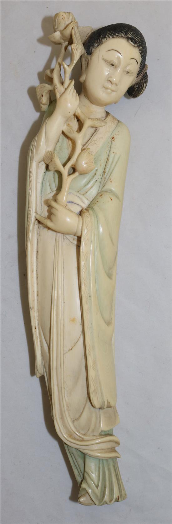 A Chinese ivory figure of a standing lady, early 20th century, 26.5cm